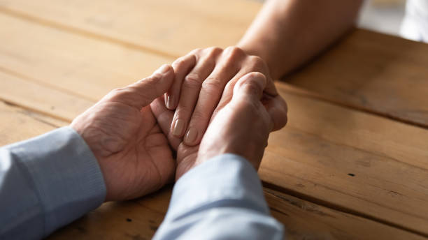 istock Loving caring older husband holding wife hand, support and empathy 1257831272