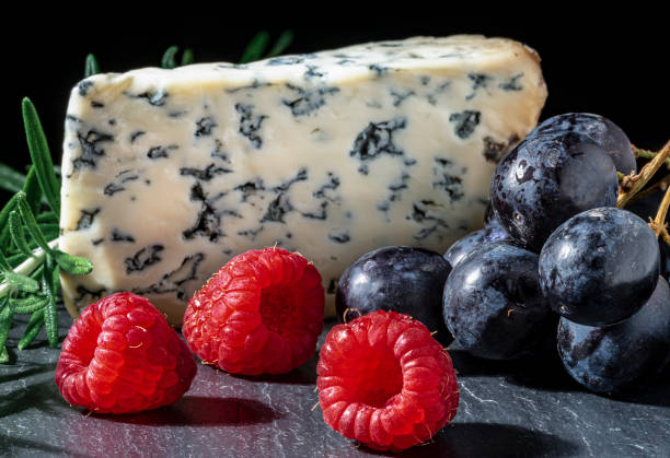 istock Blue cheese with fresh raspberries and black grapes. 1257832270