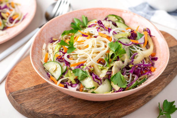 Salad with noodles, vegetables and sesame seeds Vegetarian food. Salad with noodles, vegetables and sesame seeds in a bowl close-up. Tasty and healthy food. vietnamese culture photos stock pictures, royalty-free photos & images