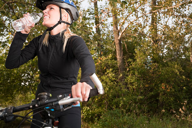 istock Young woman mountain biker drinking water 125783419