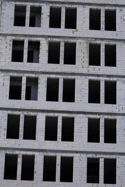 istock New multi-storey ready for commissioning white brick building against blue sky, free space for text 1257834338