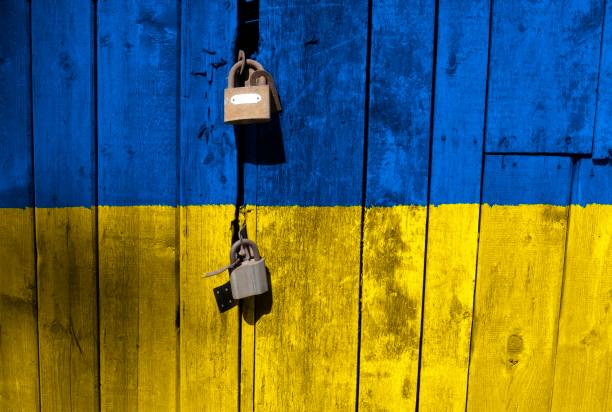 Ukrainian flag is on texture. Template. Coronavirus pandemic. Countries are closed. Locks.