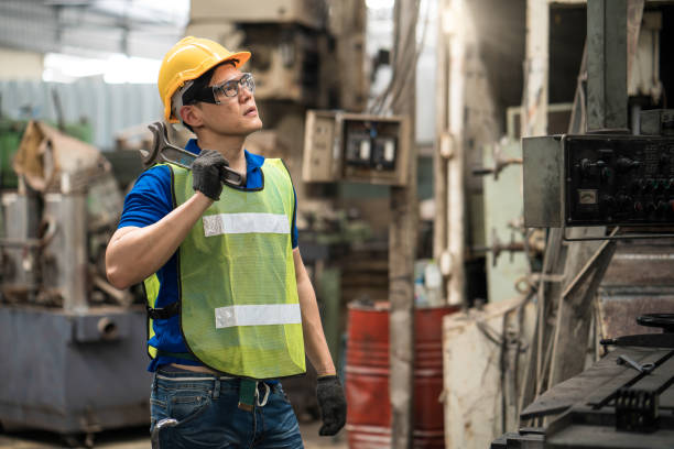 istock The technician in the factory is maintaining the machine. The technician or engineer is carrying a wrench to fix the machine. 1257836672