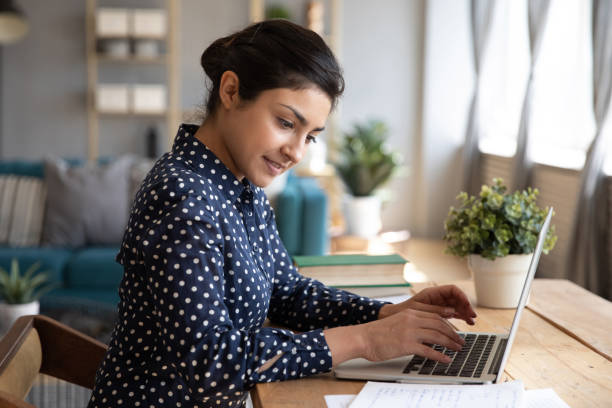 istock Young female indian student looking at paper notes, writing essay. 1257836705
