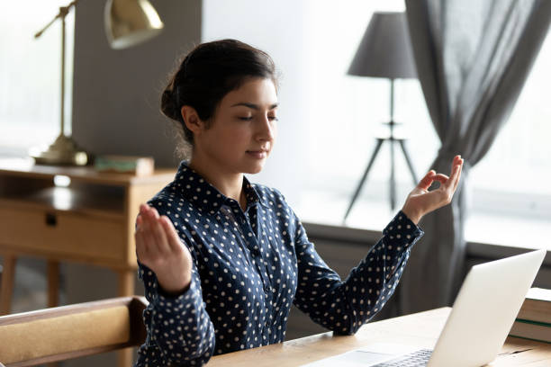 istock Mindful millennial hindu girl freelancer student reducing stress. 1257836759