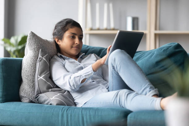 istock Pleasant young indian woman using digital computer tablet at home. 1257836849