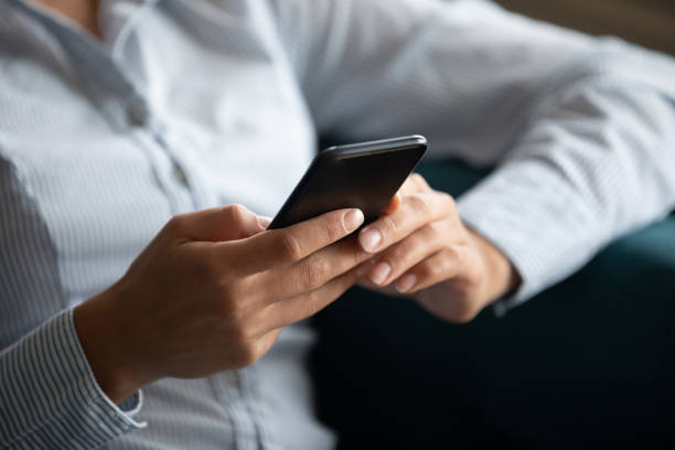 istock Close up focus on smartphone in female hands. 1257836875