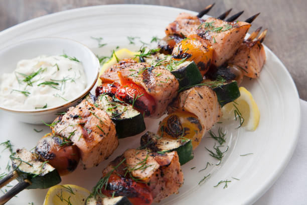 BBQ Salmon Skewers with Zucchini, Tomatoes and Tzatziki Dip BBQ Salmon Skewers with Zucchini, Tomatoes and Tzatziki Dip greek food stock pictures, royalty-free photos & images