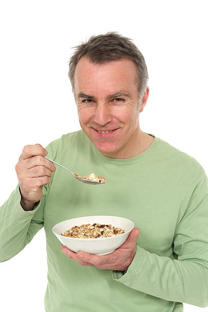 istock Man eating a bowl of muesli 125784163