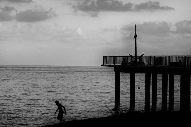 istock People by the sea at sunset 1257842612