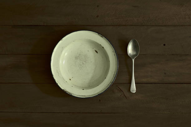 enamelled plate and spoon on wooden table