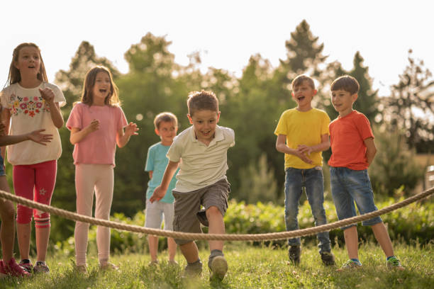 istock Playful boy is skipping jump rope 1257843689