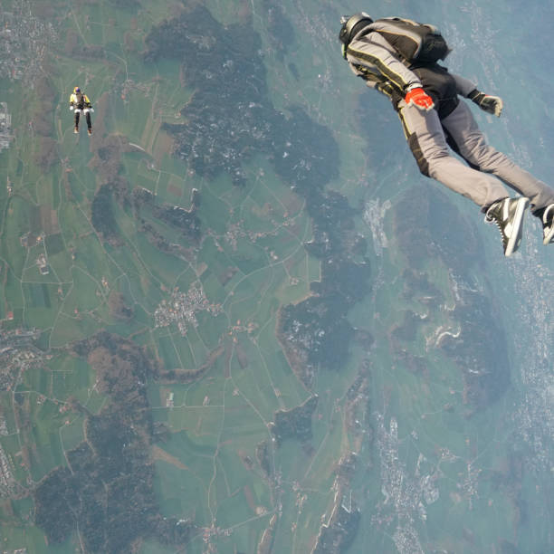 istock Freefall jumpers soar above mountain landscape 1257844002