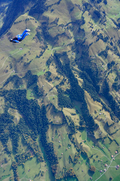 istock Freefall jumper soars above mountain landscape 1257845348