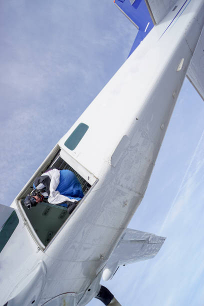 istock Wing suit soars through clear blue skies 1257845526
