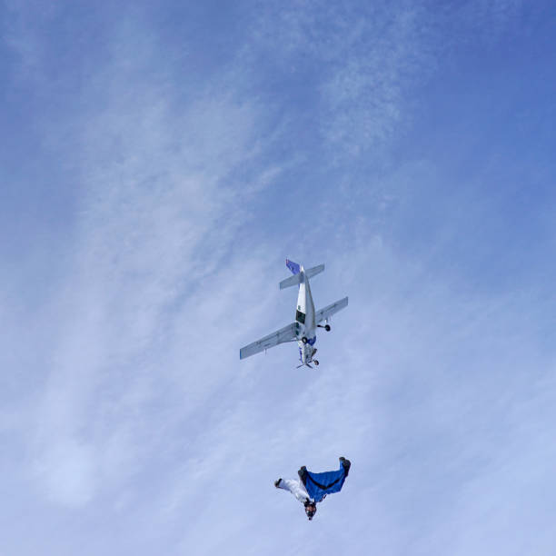 istock Wing suit soars through clear blue skies 1257845572