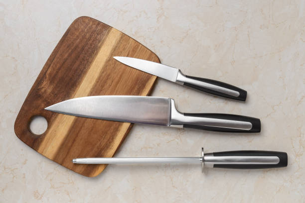 https://media.istockphoto.com/id/1257847463/photo/professional-chef-knife-peeling-knife-and-a-sharpening-steel-on-a-wooden-cutting-board-over-a.jpg?s=612x612&w=0&k=20&c=ufgP04RdZm8hDrMCIJj1sYJufq519zekfV5jwV5CJ7s=