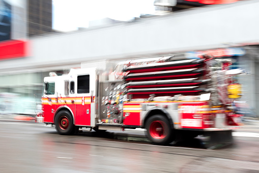 Fire engine speeding in Midtown Manhattan, motion blur, New York City.