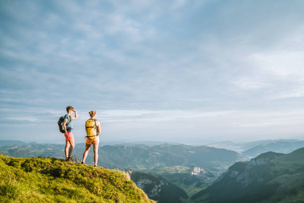 istock Trail runners ascend high mountain ridge 1257851064