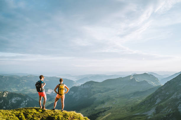 istock Trail runners ascend high mountain ridge 1257851146