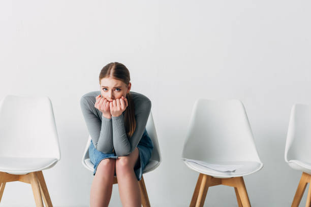 istock Scared candidate looking at camera near resume on chair in office 1257851969