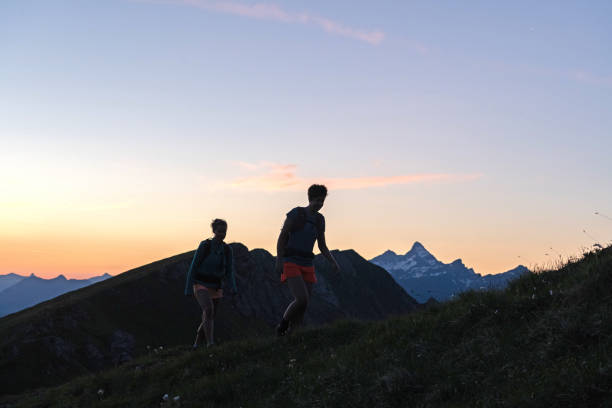 istock Trail runners ascend high mountain ridge 1257852273