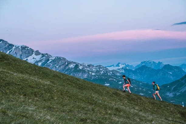 istock Trail runners ascend high mountain ridge 1257852378