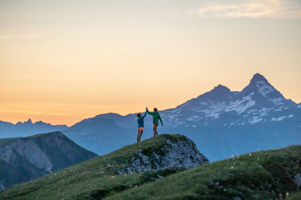 istock Trail runners ascend high mountain ridge 1257853172