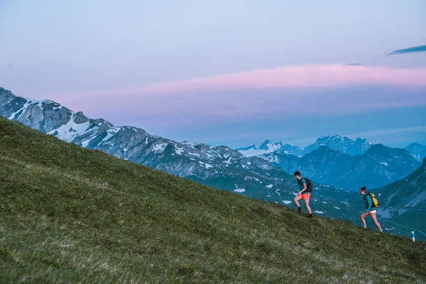 istock Trail runners ascend high mountain ridge 1257853173
