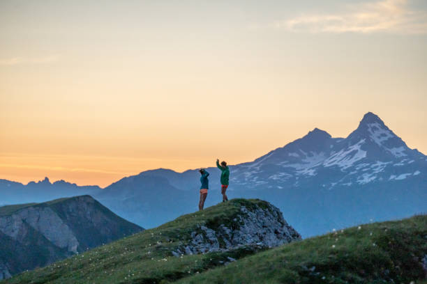 istock Trail runners ascend high mountain ridge 1257853348