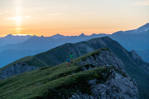 istock Trail runners ascend high mountain ridge 1257853409