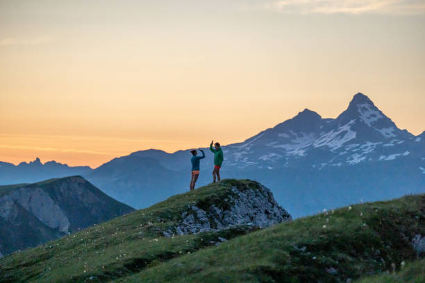 istock Trail runners ascend high mountain ridge 1257853451