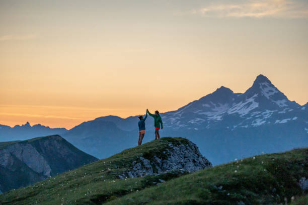 istock Trail runners ascend high mountain ridge 1257853575