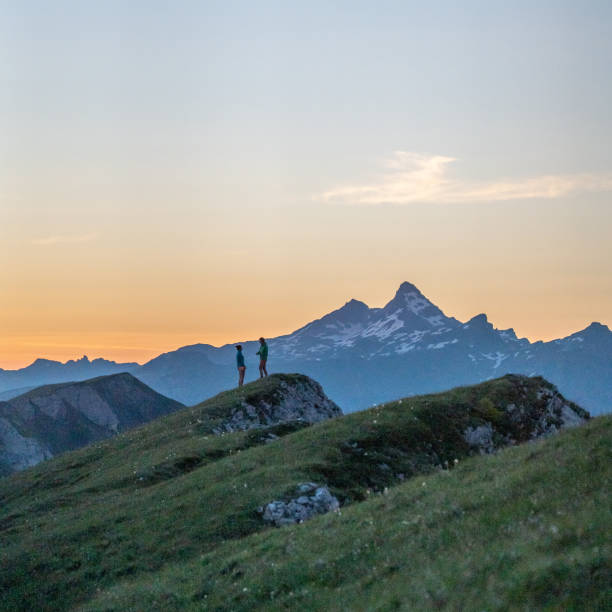 istock Trail runners ascend high mountain ridge 1257854174