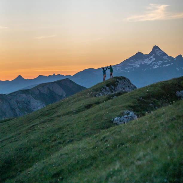 istock Trail runners ascend high mountain ridge 1257854194