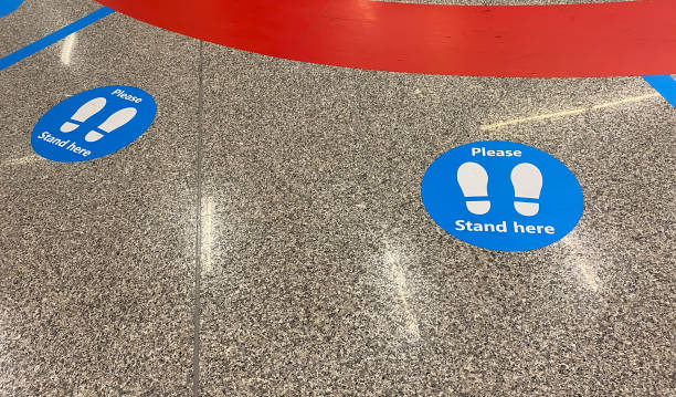 istock a sticker on the floor that warns to keep social distancing 1257854197