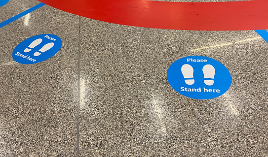 a sticker on the floor that warns to keep social distancing during the health emergency caused by the coronavirus pandemic