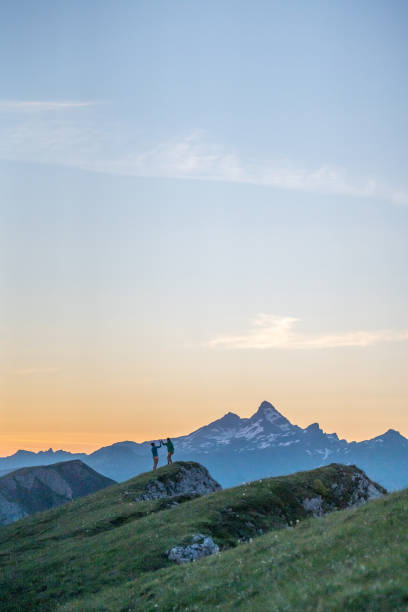 istock Trail runners ascend high mountain ridge 1257854214