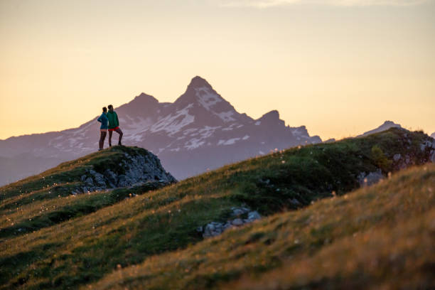 istock Trail runners ascend high mountain ridge 1257854250