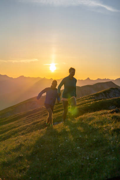 istock Trail runners ascend high mountain ridge 1257854300