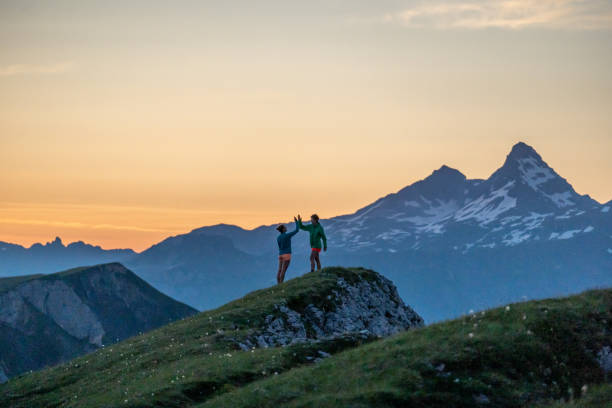 istock Trail runners ascend high mountain ridge 1257854375