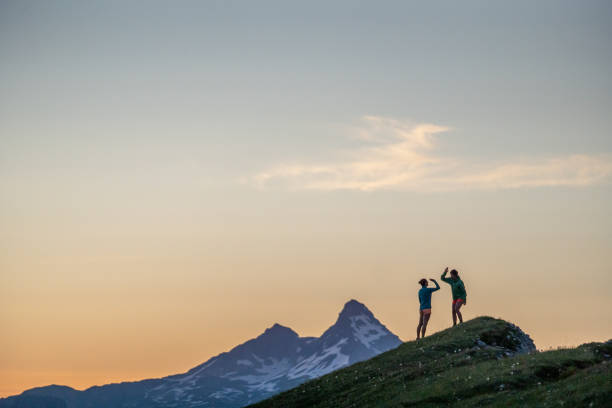 istock Trail runners ascend high mountain ridge 1257854397