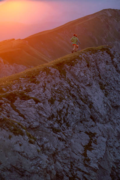 istock Trail runners ascend high mountain ridge 1257855134