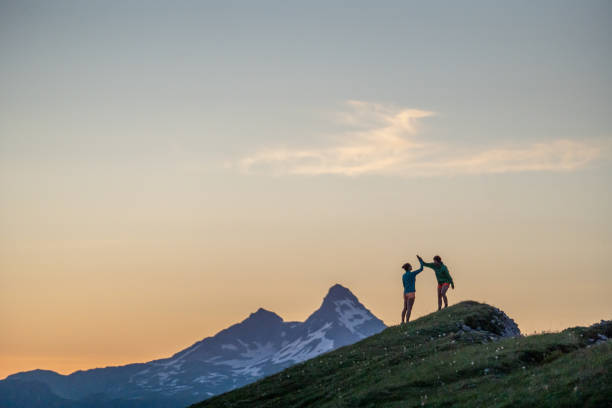istock Trail runners ascend high mountain ridge 1257855170