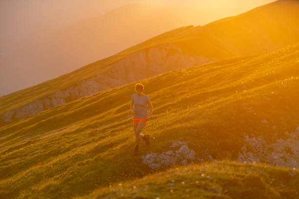 istock Trail runner ascends high mountain ridge 1257855303