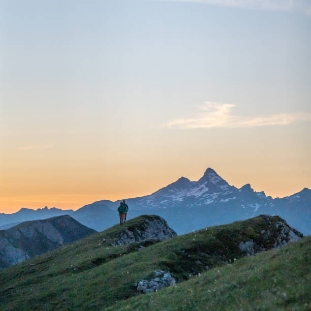 istock Trail runners ascend high mountain ridge 1257855998