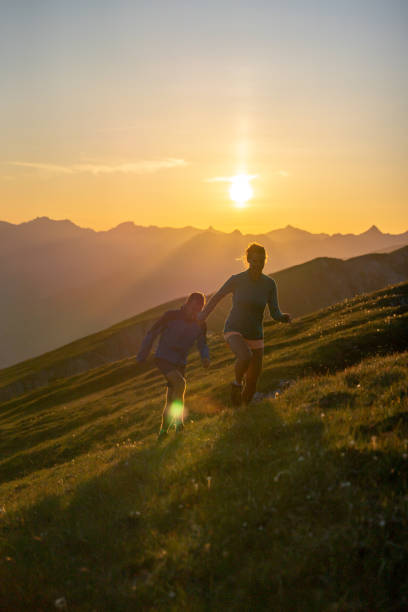istock Trail runners ascend high mountain ridge 1257855999