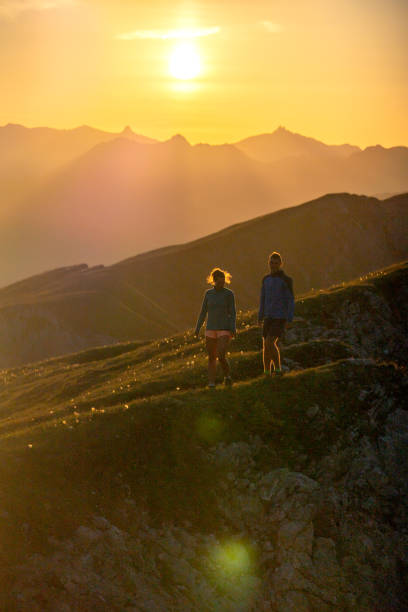 istock Trail runners ascend high mountain ridge 1257856035