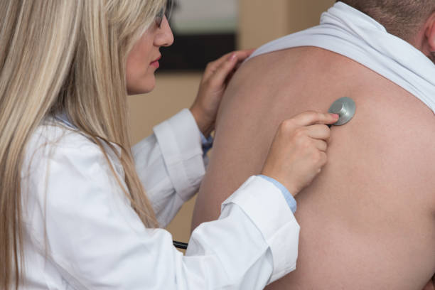 istock Listening Back Of Patient With Stethoscope 1257858312