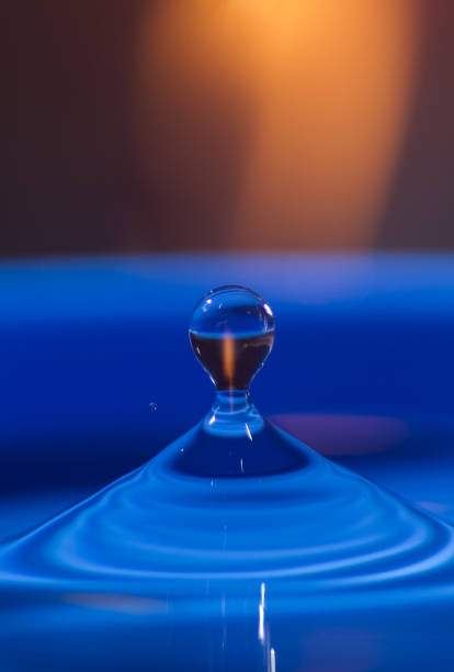 istock blue water drop close up with orange and blue colorful background 1257860257
